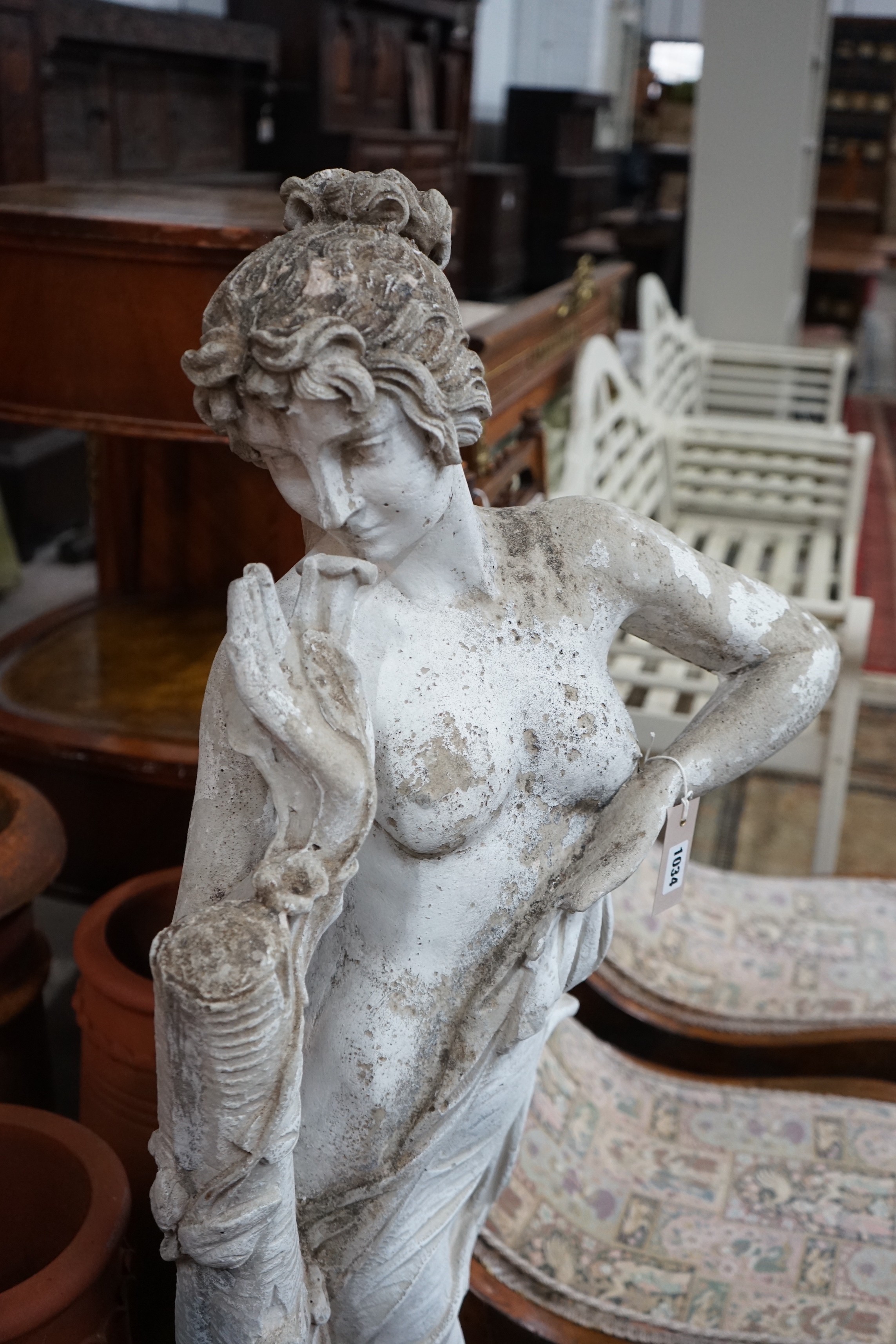 A composition stone garden ornament of a maiden with flowers, height 124cm